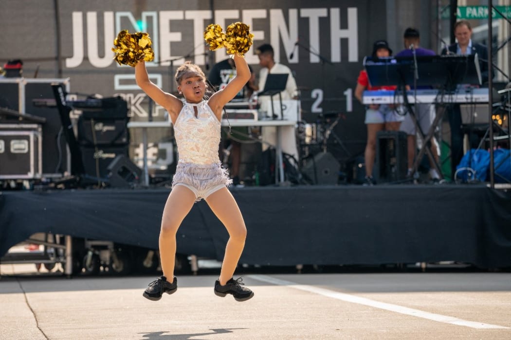 Girls from a local Black dance team perform during the annual Juneteenth block party in Cincinnati, Ohio.