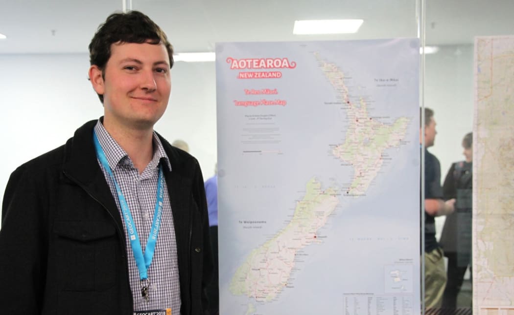 Andrew Douglas Clifford with his wall poster te reo map.