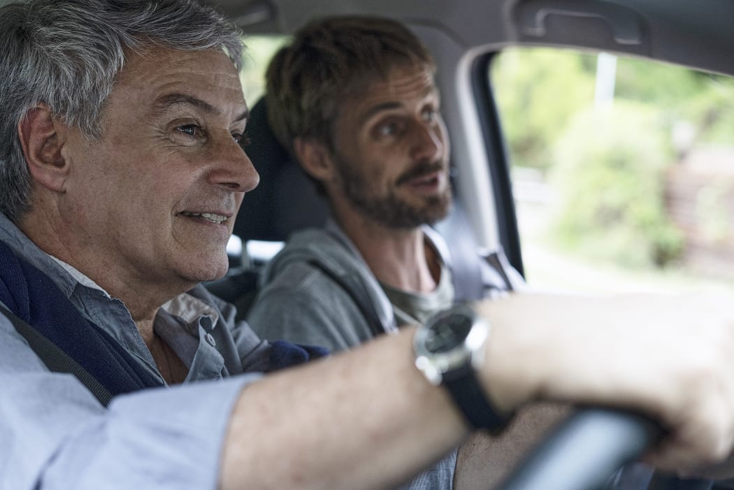 Father and son travelling by car (Photo by Frédéric Cirou / AltoPress / PhotoAlto via AFP)