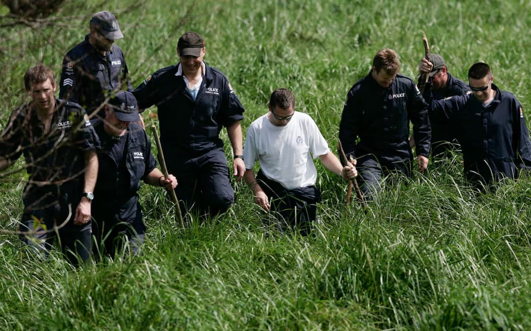 Police searching an area of interest while investigating the murder. Photo / Chris Skelton