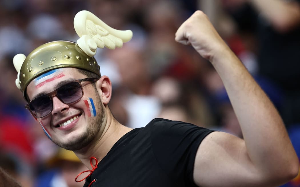 A French supporter wearing a gallic helmet gestures ahead of the France 2023 Rugby World Cup Pool A match between France and New Zealand at the Stade de France in Saint-Denis, on the outskirts of Paris on September 8, 2023. (Photo by Anne-Christine POUJOULAT / AFP)
