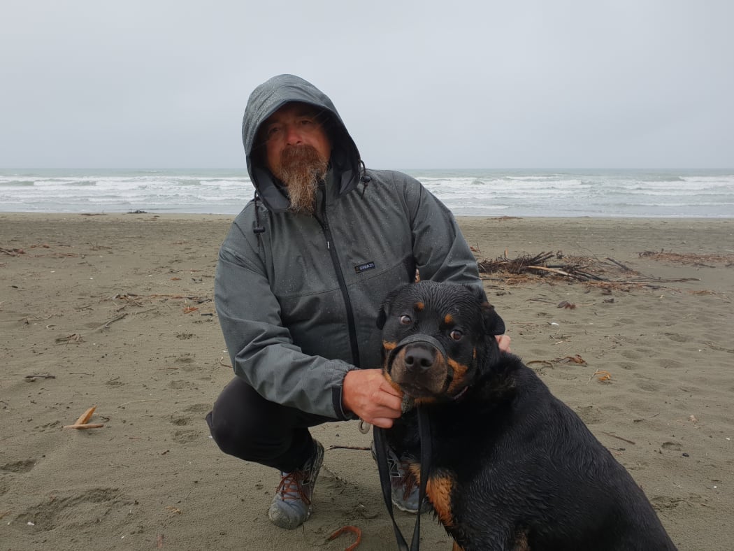 Russell Ritchie taking his dog Izza for a walk at South Brighton beach.