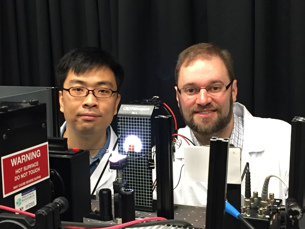 Yingzhuang Ma, left, and Jonathan Halpert are measuring the performance of a solar cell.