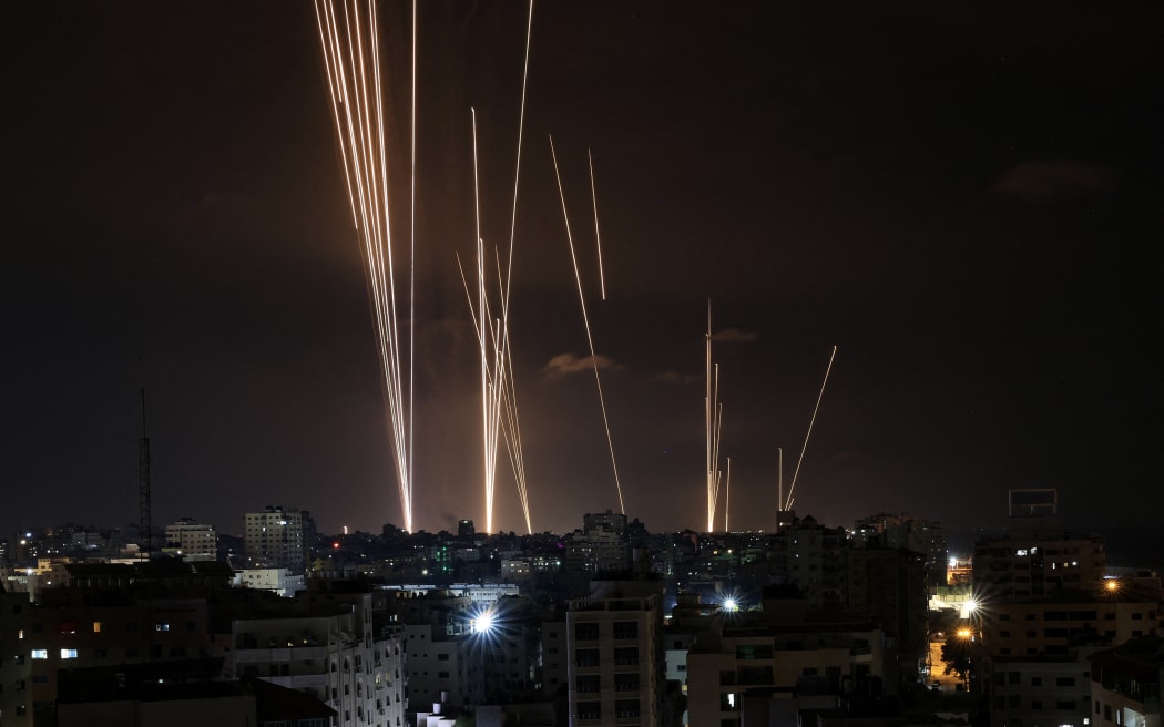 A salvo of rockets is fired by Palestinian militants from Gaza City toward Israel on October 7, 2023. At least 70 people were reported killed in Israel, while Gaza authorities released a death toll of 198 in the bloodiest escalation in the wider conflict since May 2021, with hundreds more wounded on both sides. (Photo by MAHMUD HAMS / AFP)