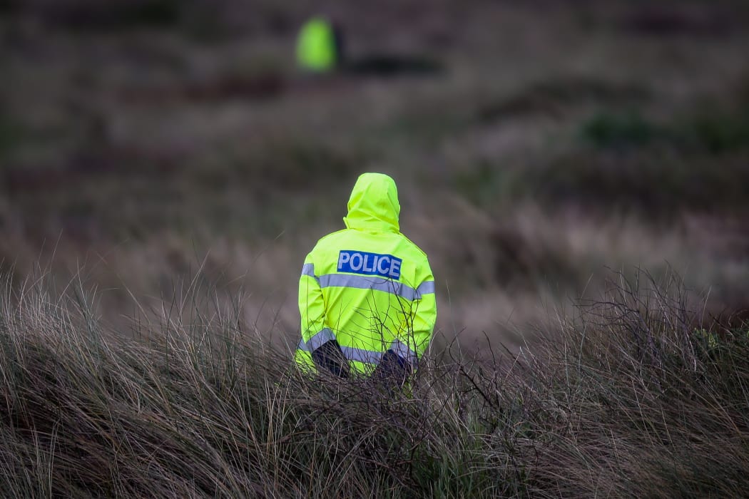 Police officer at the cordon of Alex Fisher.