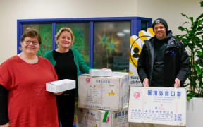 Bronwen Fox of the Disabilities Resource Centre Trust (left) picks up some face masks from Whakatāne District Council chief executive Stephanie O’Sullivan with Te Puna Ora O Mataatua  chief executive Dr Chris Tooley.