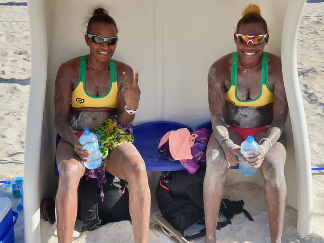 Miller Pata and Sherysyn Toko celebrate winning the Oceania Beach Volleyball Championship title.