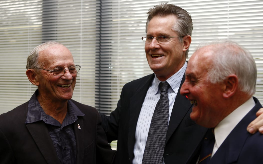 John Walker's coach Arch Jelley (L), John Walker and Walker's doctor Lloyd Drake.