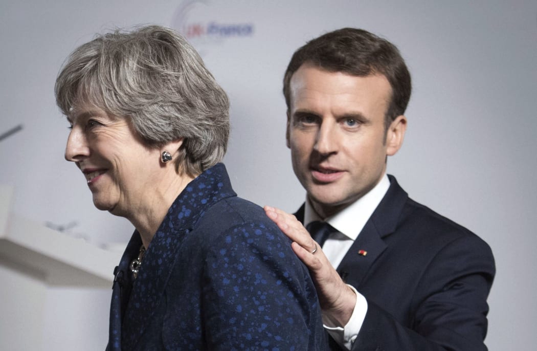 FILE - In this Thursday Jan. 18, 2018 file photo Britain's Prime Minister Theresa May and French President Emmanuel Macron during a media conference at the Royal Military Academy Sandhurst, in Camberley, England,