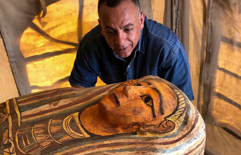 Secretary General of the Supreme Council of Antiquities Mostafa Waziri  inspects one of 2500 year-old coffins.