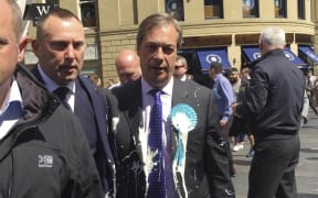 Brexit Party leader Nigel Farage after being hit with a milkshake during a campaign walkabout for the upcoming European elections in Newcastle, England, Monday May 20.