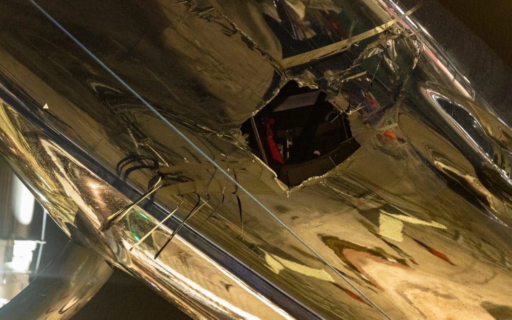 The extent of the damage to American Magic's AC75, Patriot is revealed as the yacht is lifted out of the water at the team's Auckland base.