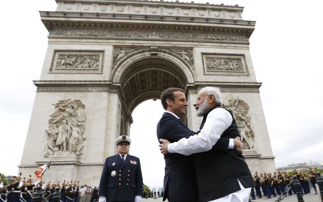 Indian Prime Minister Narendra Modi says goodbye to French President Emmanuel Macron after a ceremony at the Arc de Triomphe on the last leg of his four-nation visit in Paris.