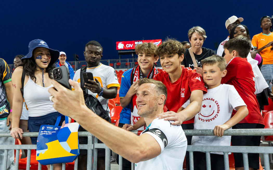 Chris Wood takes a selfie with fans after defeating Cote d'Ivoire.