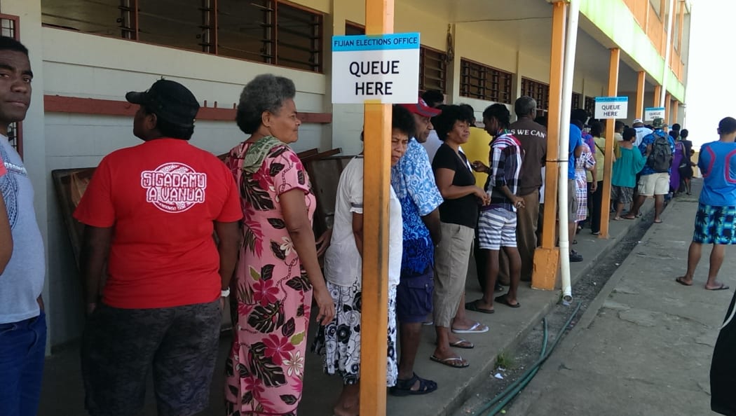 Voters in Fiji's election queue at John Wesley College, Suva.