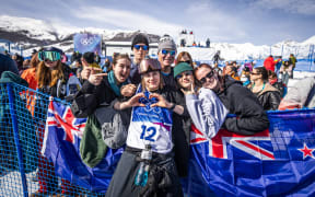 Mischa Thomas hugs her family after placing 8th in the Women's Freeski Halfpipe Final at the 2026 Winter Olympics.