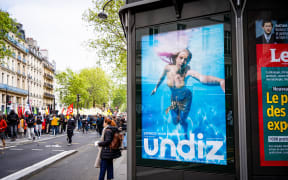 This ad for togs on display in Paris has proved controversial because of its AI-generated imagery, 29 April, 2023.