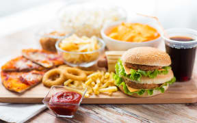 Close up of fast food snacks and drink on table.