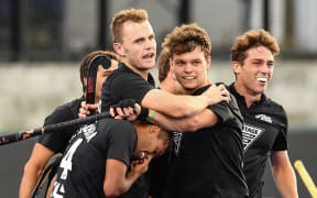 Black Sticks team mates celebrate.