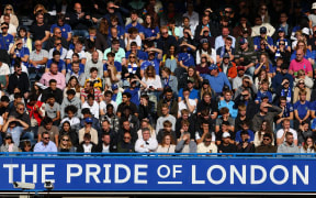 Chelsea fans looking on from the stands at Stamford Bridge.