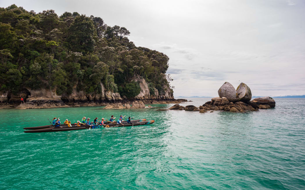 The double-hulled waka at Split Apple Rock, near the Abel Tasman National Park