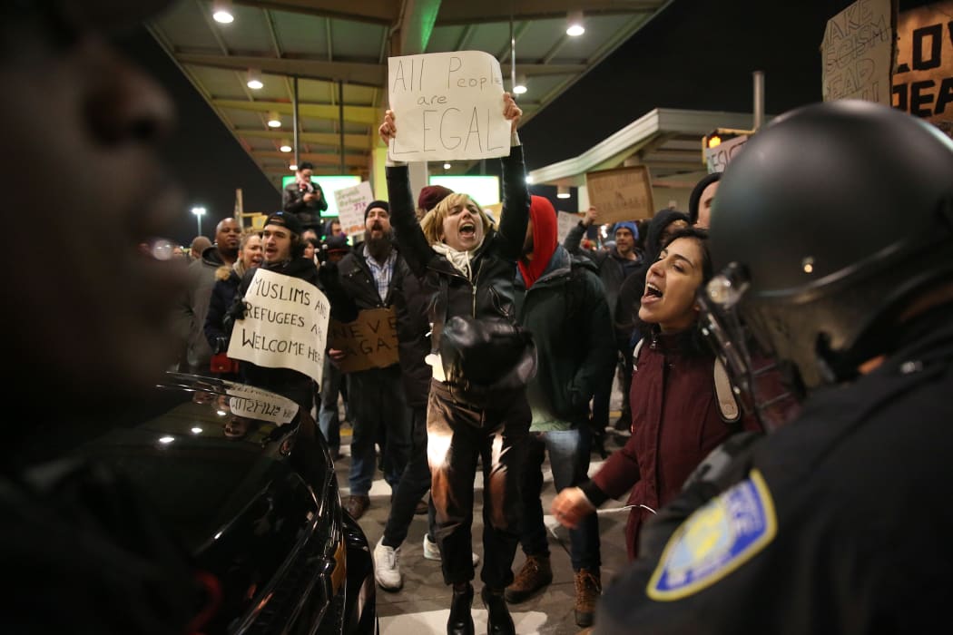 JANUARY 28: Police members intervene and arrest some of activists during the protest against President Donald Trump's 90-days ban of entry on 7 Muslim-majority countries in the Fourth terminal of JFK airport in New York, U.S.A