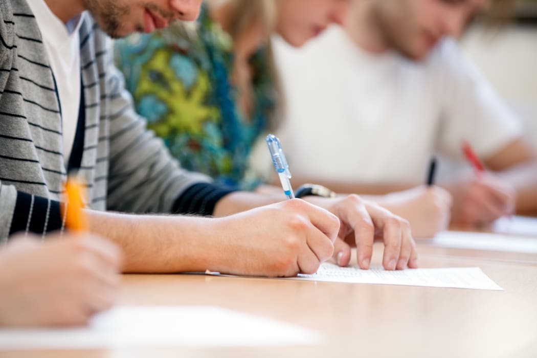 21790139 - writing hands of students at course