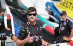 Emirates Team New Zealand's skipper Peter Burling gives on thumb up on the pier prior the 37th America's Cup first preliminary regatta, off the coast of Vilanova i la Geltru on September 16, 2023. After this first preliminary regatta the teams will head to Jeddah, Saudi Arabia, for a second regatta between November 29 to December 2, 2023. The third and last preliminary regatta will be held in August 2024 in Barcelona where all the America’s Cup teams will race in their new AC75s for the very first time. (Photo by LLUIS GENE / AFP)