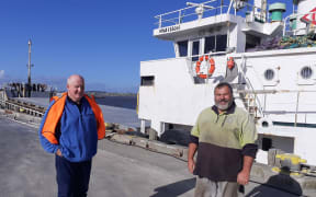 Coastal Bulk Shipping general manager Doug Smith, left, and Whanganui Port worker Greg Robinson at Wharf No. 1.