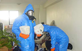Workers at a contaminated property.