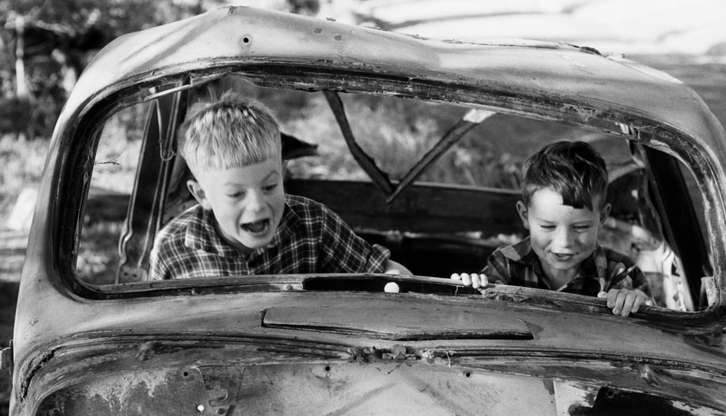 Two boys playing in wrecked car, 1957, North Island, by Eric Lee-Johnson.