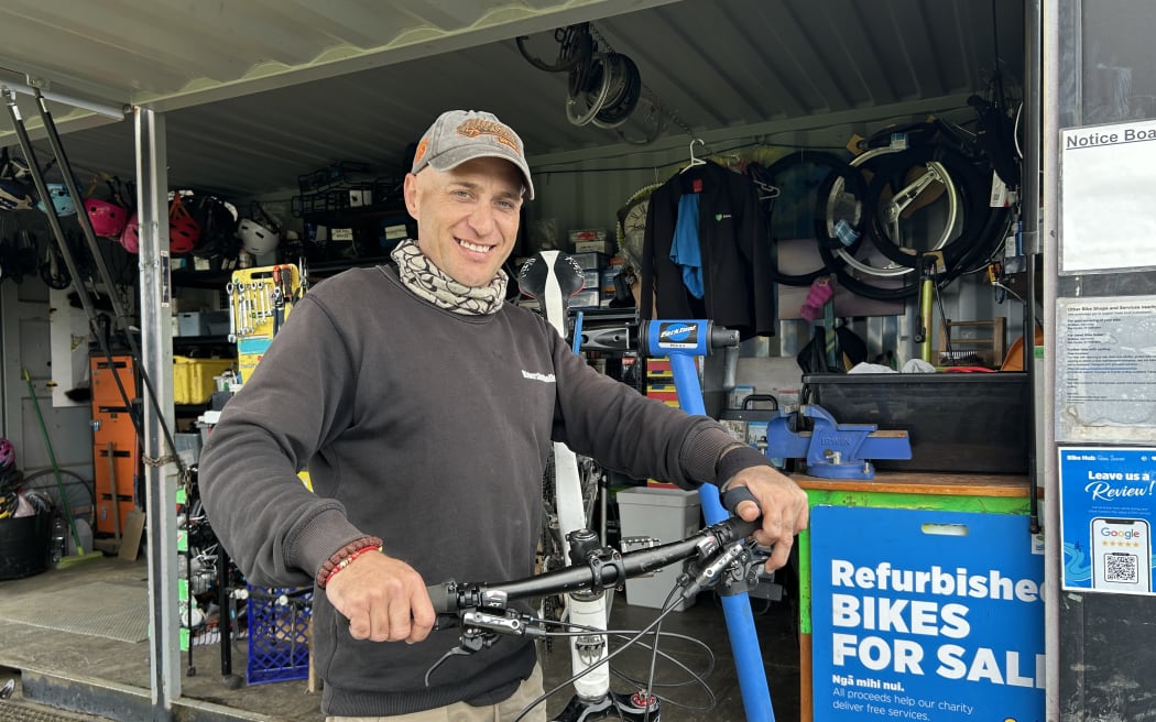Picture of a man holding a bike.