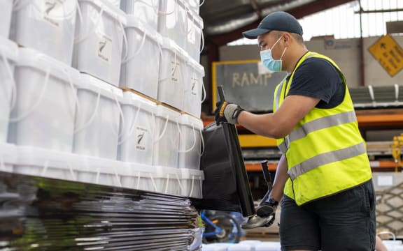 Air crew stack and secure pallets of disaster relief supplies to be sent to Tonga by Royal New Zealand Air Force, in the wake of a tsunami triggered by a volcanic eruption in January.