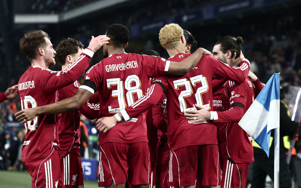 Liverpool's Dominik Szoboszlai, right, celebrates with teammates after scoring his team's first goal during the UEFA Champions League match against Olympique de Marseille (OM) in Marseille, 21 January 2026. (Photo by Thibaud MORITZ / AFP)