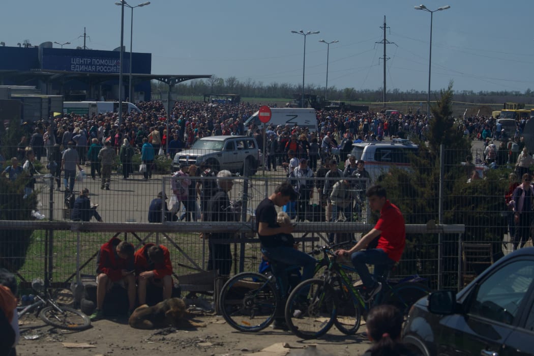 People gather to receive humanitarian aid in a car park in Mariupol on 29 April.