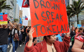 A Tokelaun woman brings her climate message to the Auckland rally.