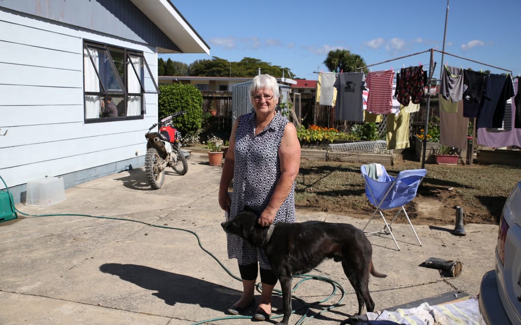 Antoinette Spencer in front of her home.