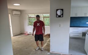 Tom White inside his flood damaged home in Swanson.