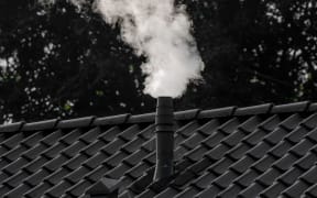 Chimney with smoke coming out of it.