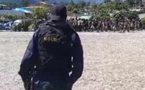 Papua New Guinea K-9 Unit member guards at the Porgera mining site as protesters from warring tribes gather. September 2024