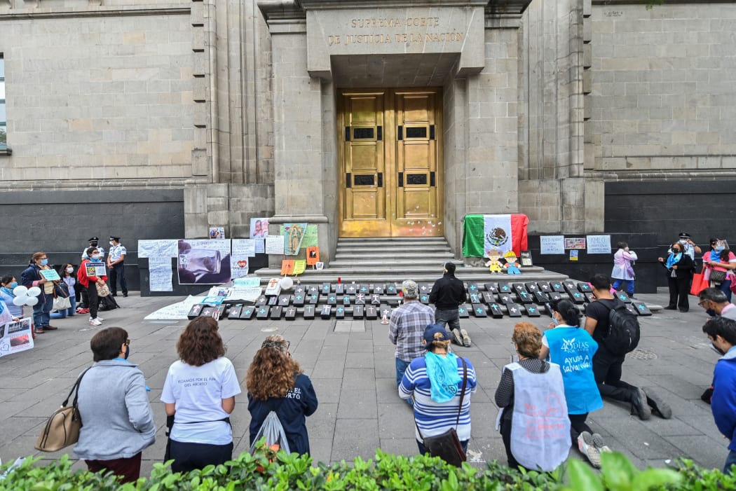 (FILES) In this file photo taken on July 29, 2020 Catholic anti-abortion activists pray during a protest outside the Mexican Supreme Court building in Mexico City, amid the novel coronavirus pandemic.
