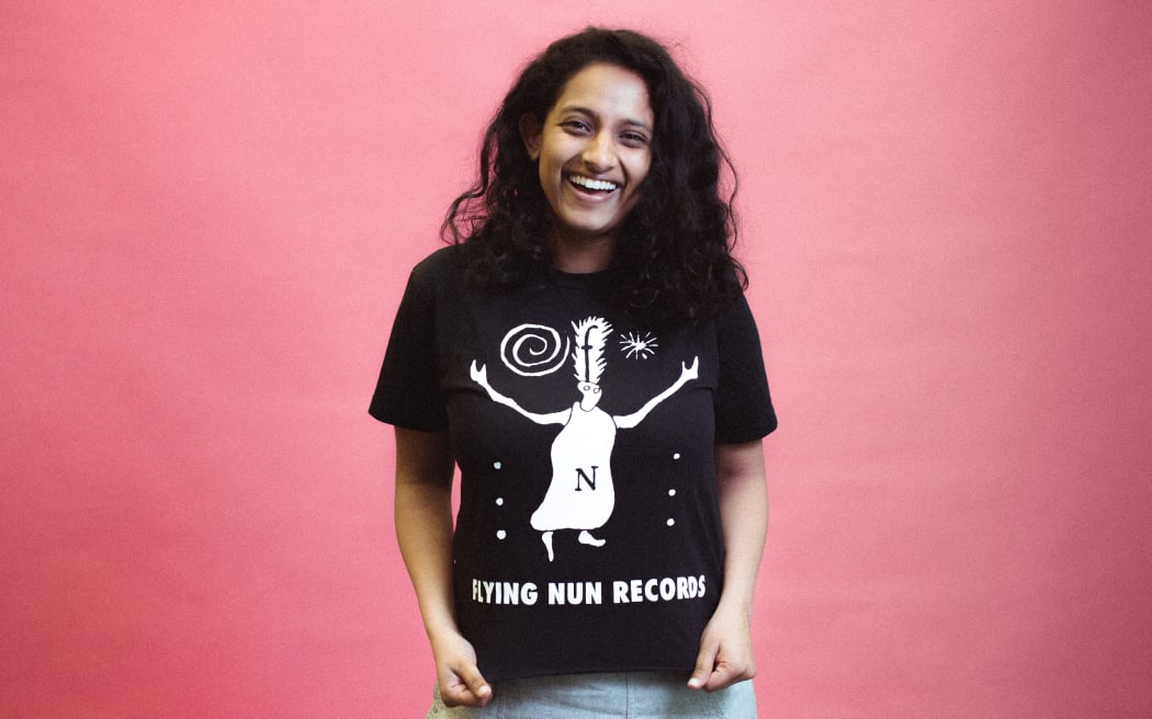 Associate producer of RNZ podcast The Detail, Kethaki Masilamani in her Flying Nun t-shirt