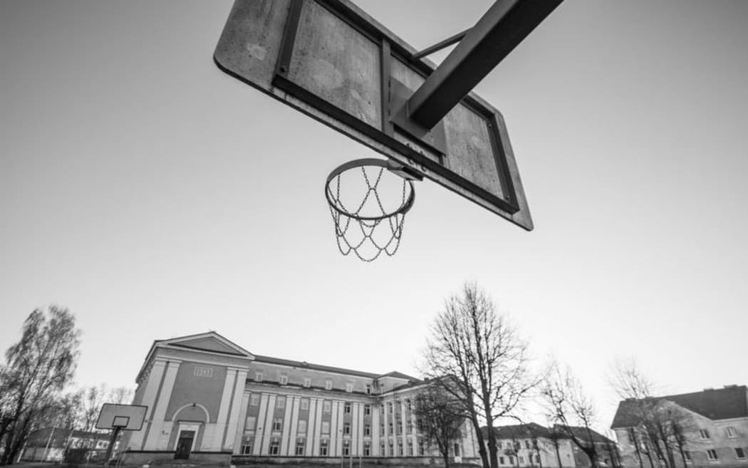 School building with basketball hoop.