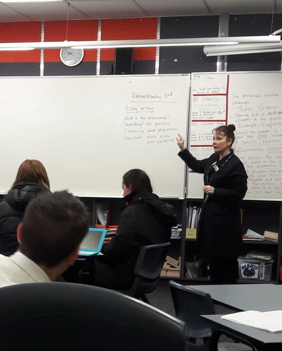 Tania Kelly Roxborogh in a classroom with students.