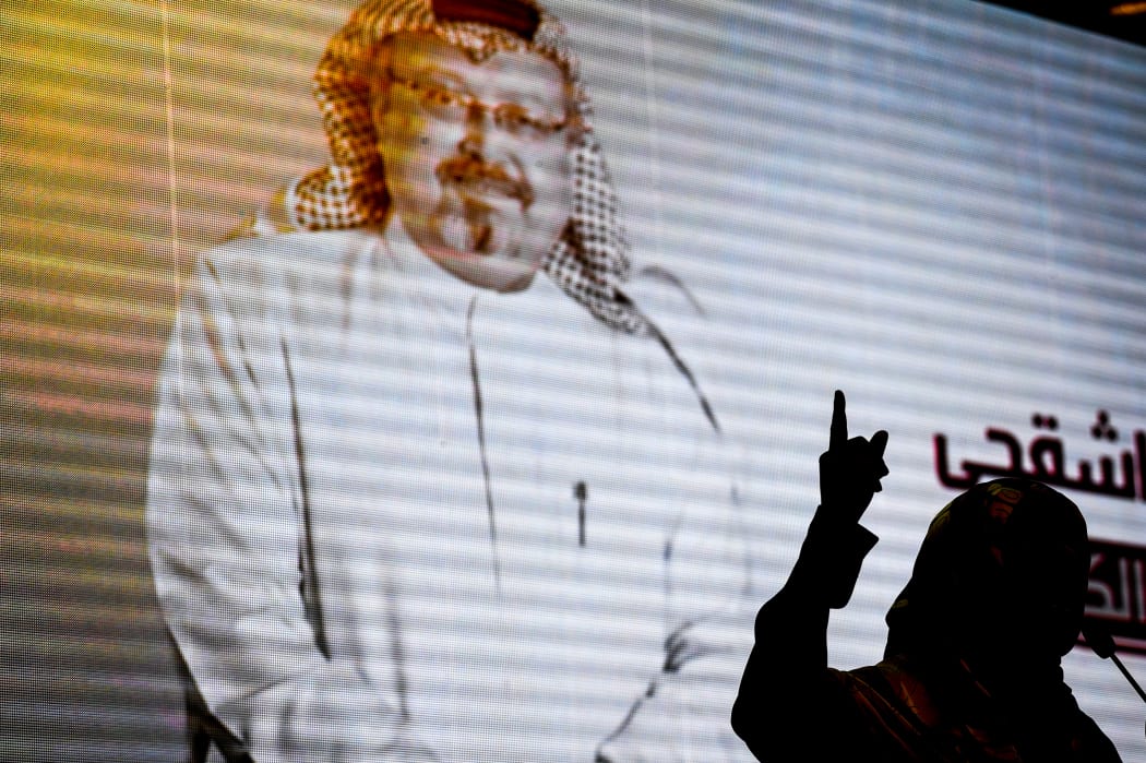 Nobel Peace Prize laureate Yemeni Tawakkol Karman stands in front of a digital image of Jamal Khashoggi as she speaks during a commemoration event of Khashoggi's supporters.