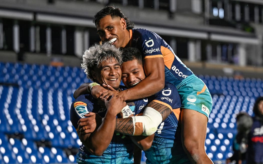 Fine Inisi of Moana Pasifika celebrates his try with team.