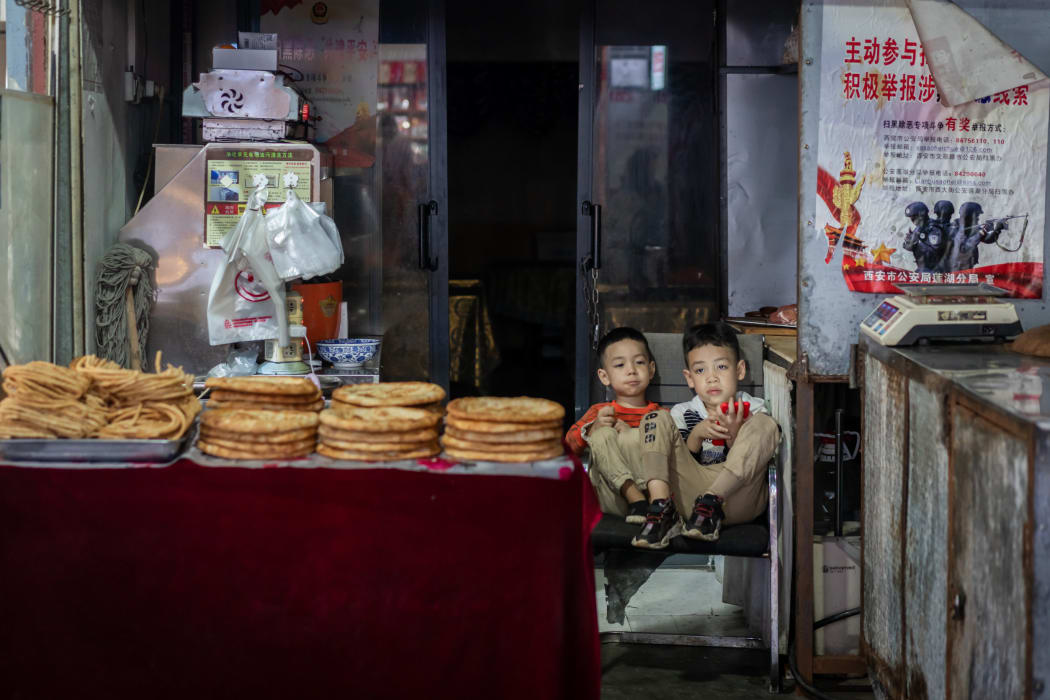 Brothers at a bakery in the Muslim quarter in Xi'an city, China.