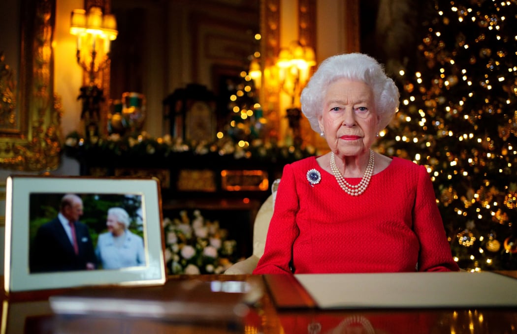 Queen Elizabeth II during her annual Christmas Day message, with a photograph of herself and her late husband Prince Philip, Duke of Edinburgh, in the White Drawing Room Windsor Castle on December 23, 2021.