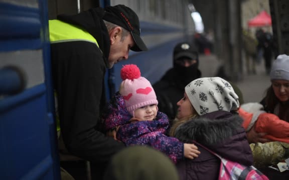 People fleeing Ukraine board a train in Lviv, in the west of the country, en route to Poland, 3 March 2022.