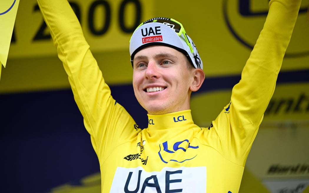 Slovenian Tadej Pogacar of UAE Team Emirates celebrates on the podium after winning stage 19 of the 2024 Tour de France cycling race, from Embrun to Isola 2000 (144,6 km), in France, on Friday 19 July 2024. The 111th edition of the Tour de France starts on Saturday 29 June and will finish in Nice, France on 21 July. BELGA PHOTO TOM GOYVAERTS (Photo by Tom Goyvaerts / BELGA MAG / Belga via AFP)